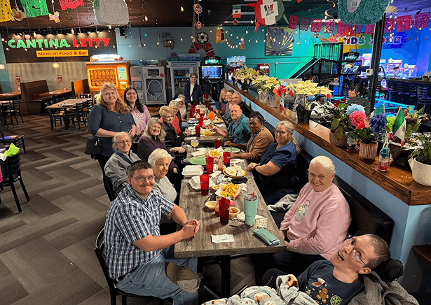 REPLACE → big celebration table / event spread / happy group party at the cantina